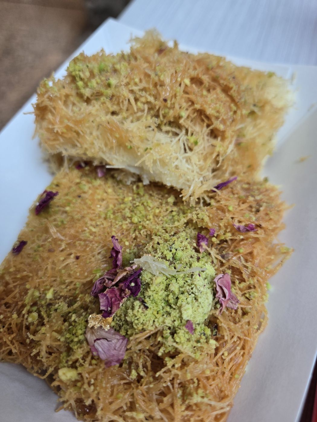 Kunafa topped with pistachios and rose petals