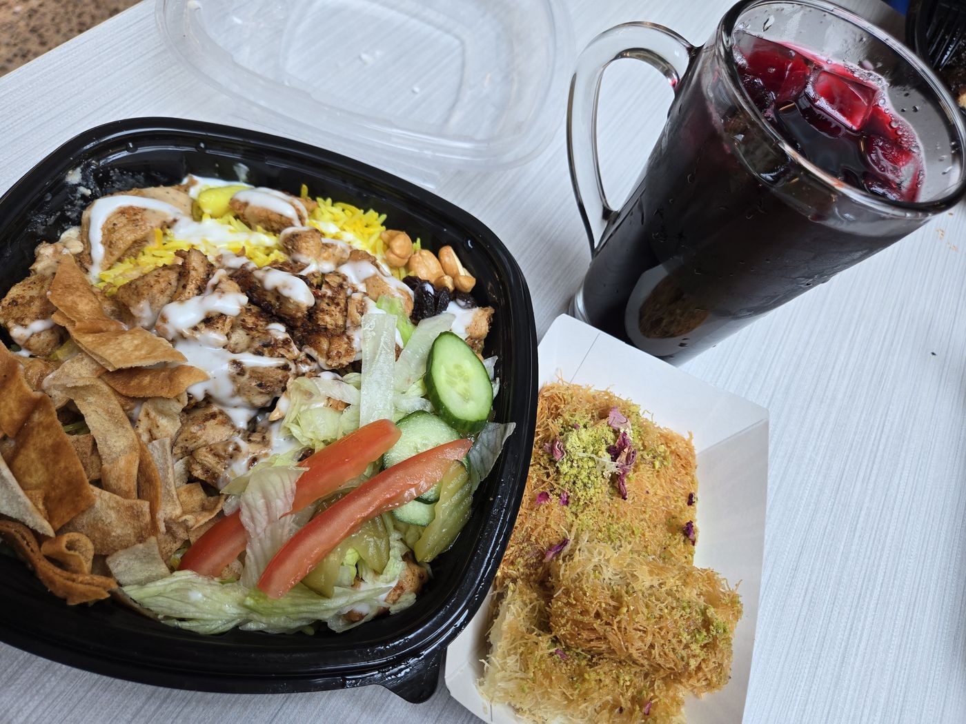 Shawarma over yellow rice with kunafa and a hibiscus drink at Egyptian Bites